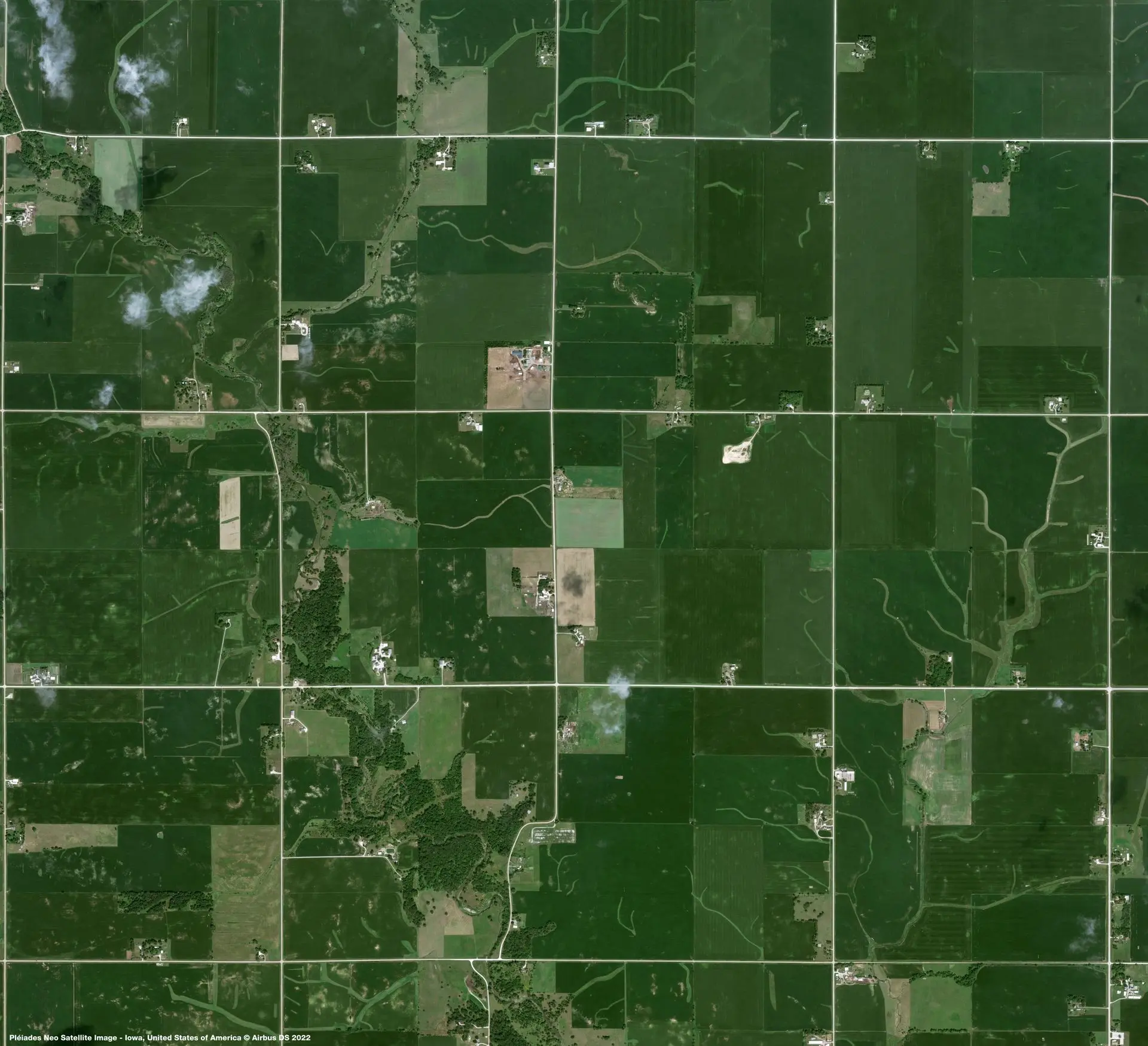 Satellite view of agricultural parcels, roads, and waterways used for geospatial mapping
